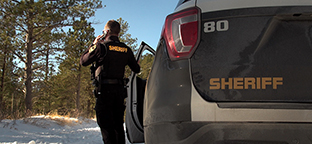 A Pennington County Sheriff deputy in South Dakota makes a call in a rural part of South Dakota. The department is on FirstNet for its reliability and connectivity.